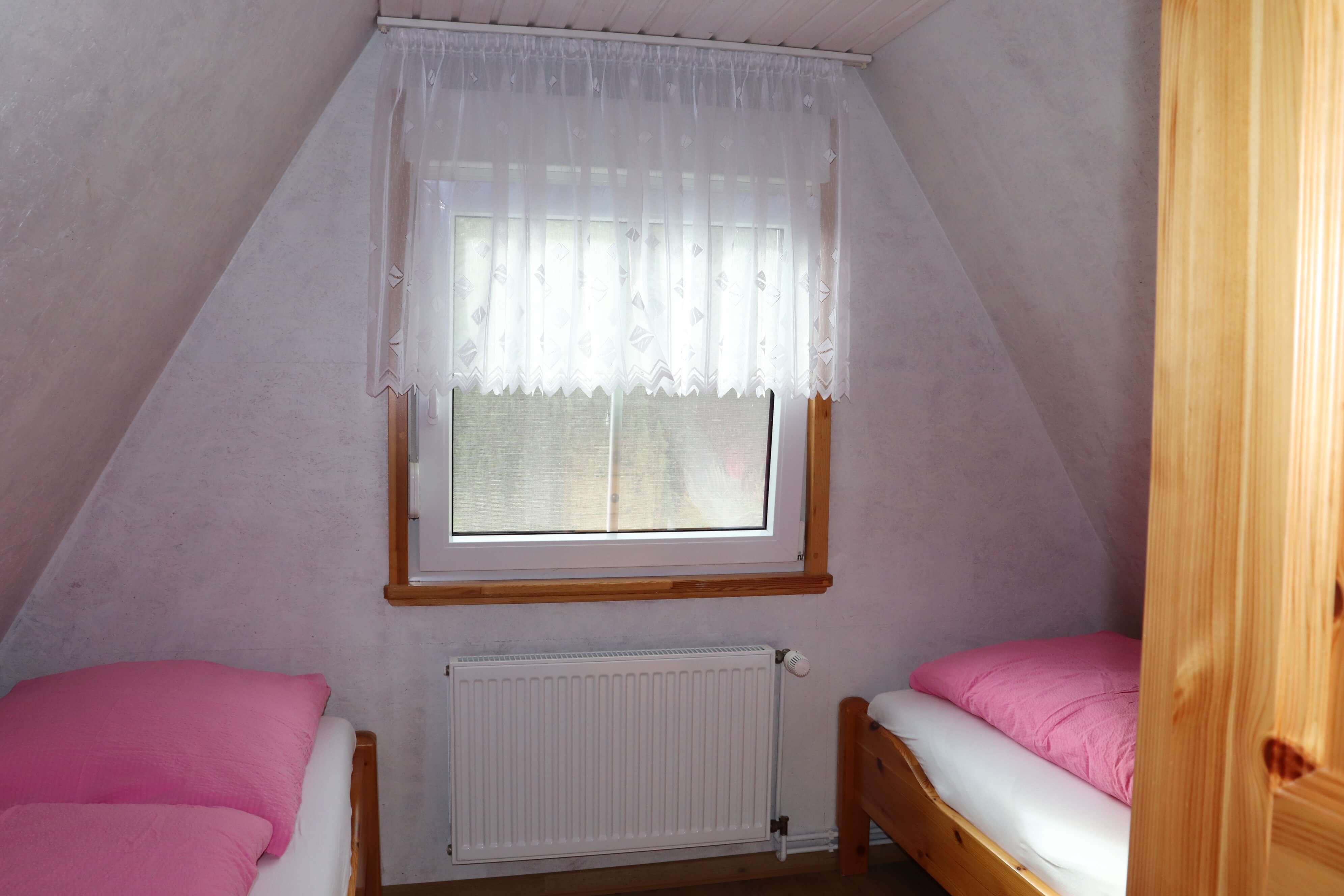 Schlafzimmer mit zwei einzelnen Betten und Ausblick auf den Sternberger See.